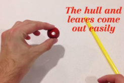 Hull a strawberry with a drinking straw