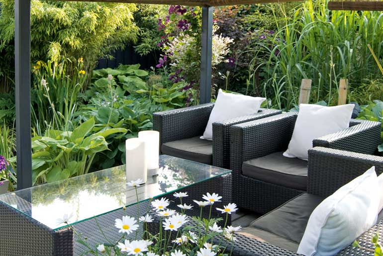 Create a lush tropical outdoor space with shade-loving plants. Image: Getty Images