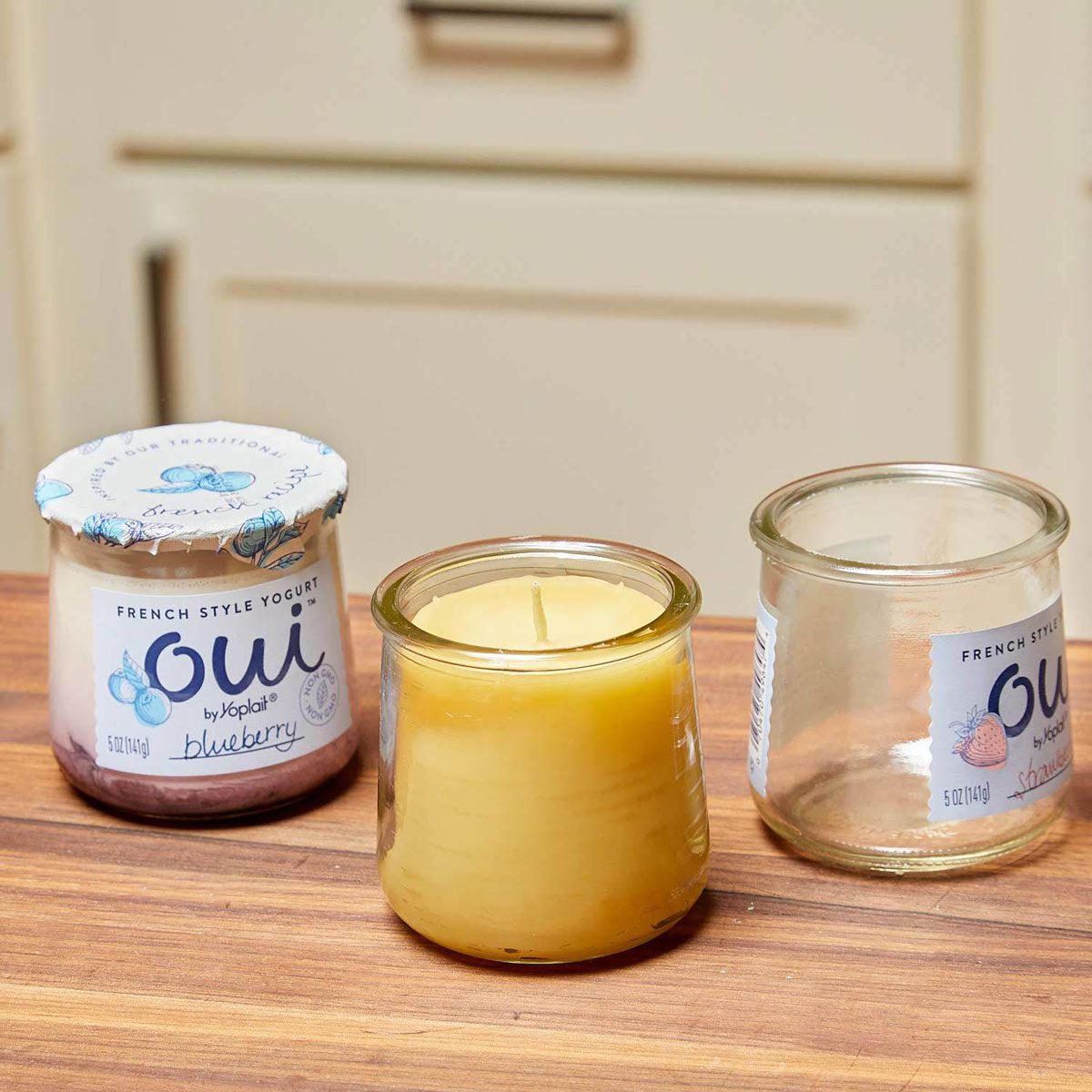 Glass yoghurt jars make great candle containers